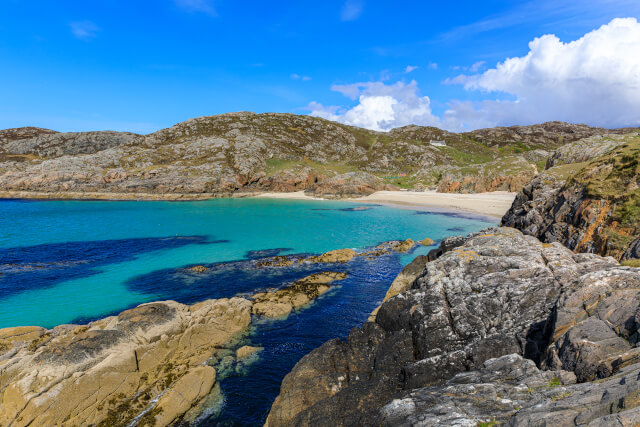 Achmelvich Beach - Lochinver, West Highlands, Scotland. Beautiful, white sanded cove surrounded by rocks. Sea colour is a glorious shade of blue.
