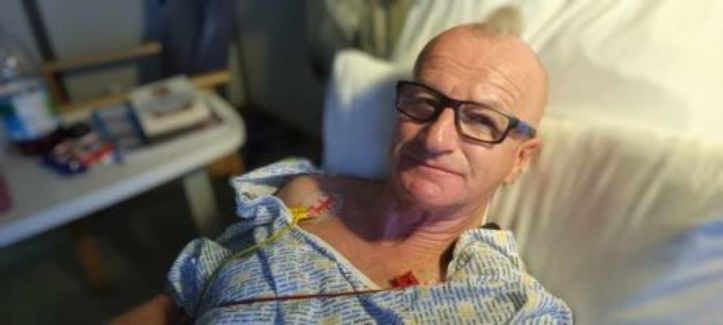 The author lying in a hospital bed following a Sudden Cardiac Arrest in April 2023.